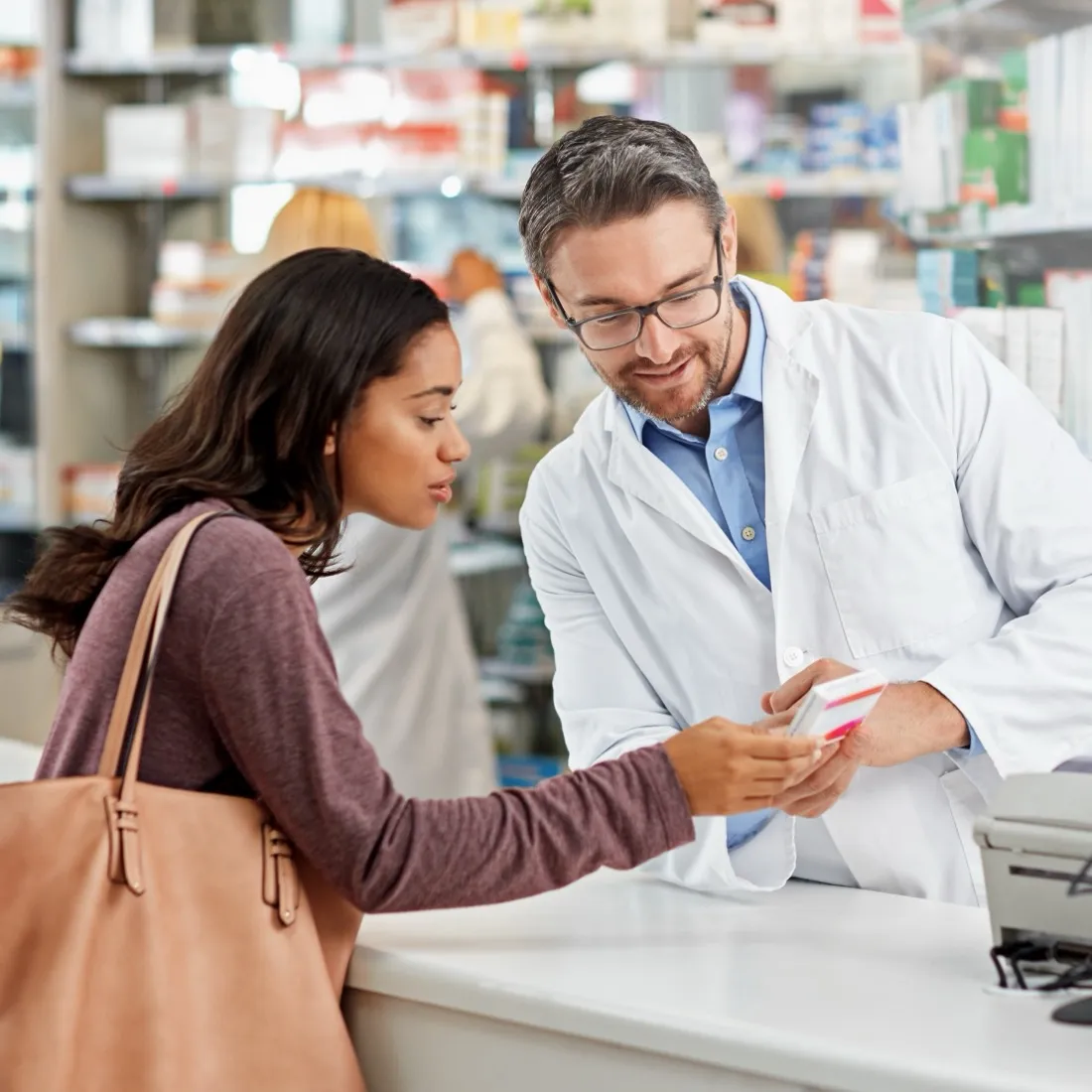 Pharmacist helping a customer at the counter