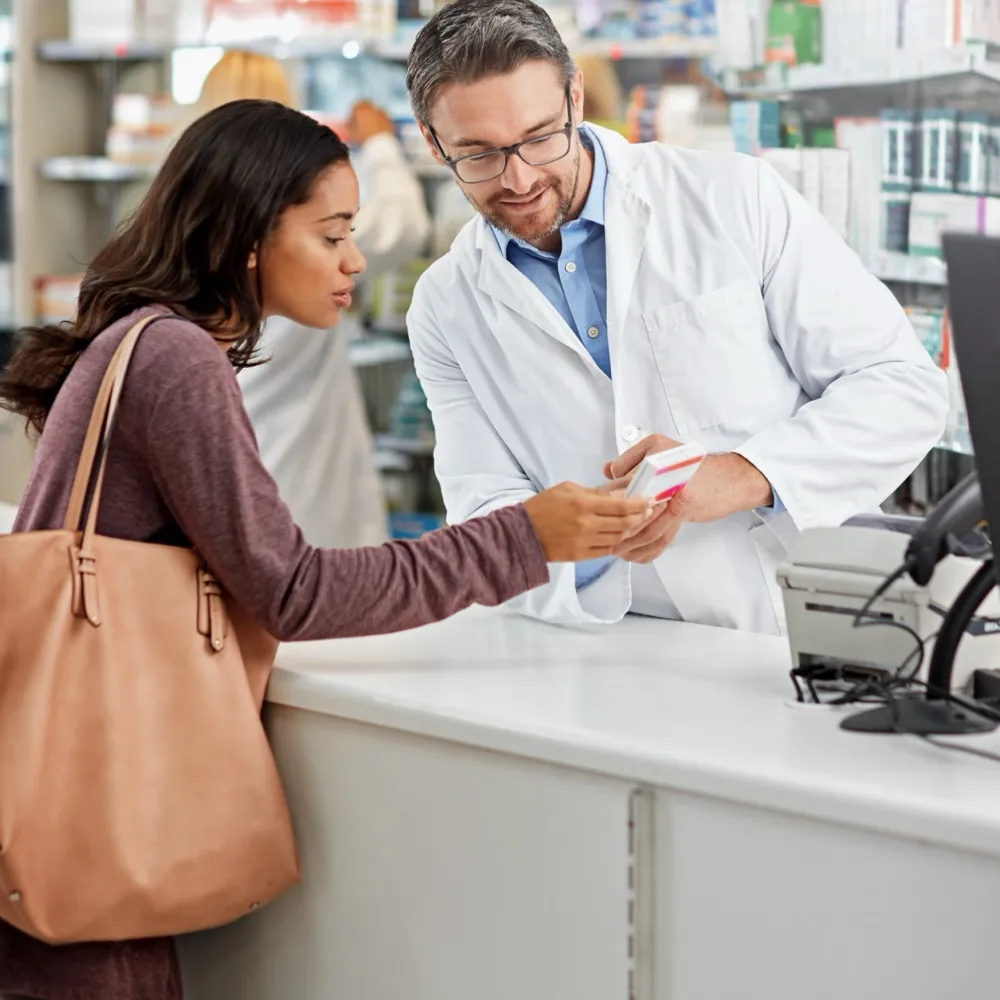 Pharmacist helping a customer at the counter